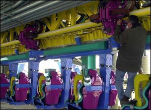 Maintenance foreman Rick Hiser checks the wheel clearance of one of the park's rides.