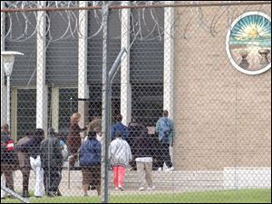 A large group of family members enters the Southern Ohio Correctional Facility.