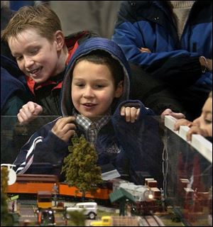 Cousins Jesse Oswanski of Sylvania, foreground, and Michael Rader of South Toledo watch a model train during the Big Train Show in December. The spring show takes place Sunday.