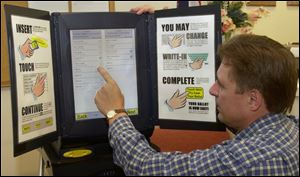 Mark Beckstrand, a vice president of Sequoia Voting Systems, Inc., demonstrates the new touch-screen voting system.