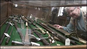 Doris Danekind, secretary of the Oregon-Jerusalem Historical Society, looks over the Civil War weapons in the society's museum.