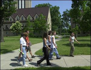 Abi Good, right, leads a group of incoming freshmen and potential students on a tour of the University of Toledo.