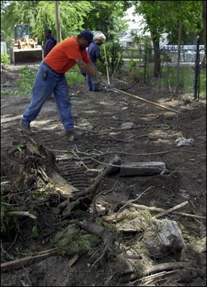 City employees clean the alley behind the 1300 block of Hamilton Street.