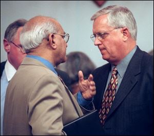 Dr. Vik Kapoor, left, and Ronald Langenderfer confer in October, l999. Mr Langenerfer was an early and strong supporter of Dr. Kapoor's candidacy for UT president.