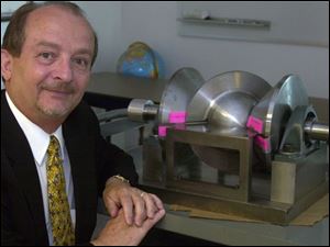 Ron McMaster, with the lightweight spherical engine that has a round 'wobble plate.'