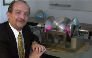 Ron McMaster, with the lightweight spherical engine that has a round 'wobble plate.'