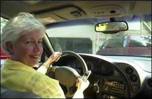 Peg Briggs makes a commute of 70 miles, driveway to driveway, from her home to her job in Livonia, Mich.