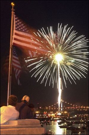 Fireworks light up the night sky over the Maumee River in Toledo in this time-exposure photograph taken from the Martin Luther King, Jr., Bridge. The Promenade Park display was one of about 25 in northwest Ohio and southeast Michigan.