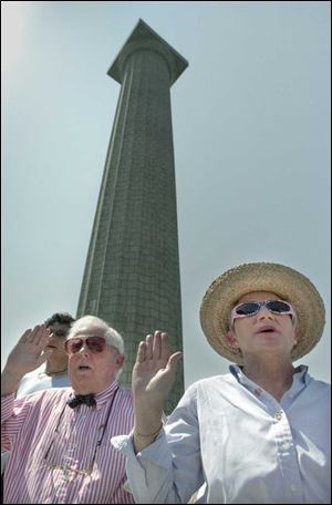 Kenneth and Myra McClure, above, who came here from Canada, take the oath of citizen- ship at Perry's Victory and International Peace Memorial.
 