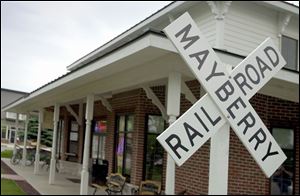 The Mayberry Railroad cross sign marks Mayberry Square, a traditional neighborhood development off of Sylvania-Metamora Road.