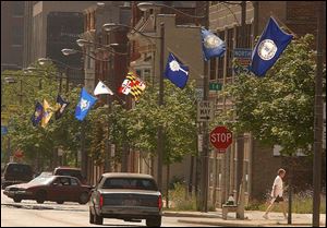 Flags of the 50 U.S. states and several territories line Adams Street between 11th and 22nd streets in the Uptown district.
