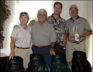 PRO-AM WINNERS: Jamie Farr presents awards to the Fifth Third pro-am winners, Ray Marvin and Mark Clark, at right. The two golfed with LPGA pro Carri Wood, at left. John Porter and Errol Craddolph also were on the team.