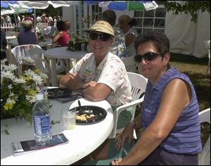 CHAMPIONS TENT PATIO: Laurie Gladieux and Jane Larsen catch the view during lunch.