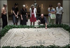 Participants admire a mosaic at the Museum of Art. From left are Franklin Thompson, Naomi Morisita, Priscilla Boike, Carol Strup, Bob Callans, Mayumi Balfour, and Donald Bergstrom.