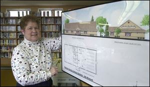 Barb Drodt, Ida librarian, has more than one reason to be happy to get a new library building.