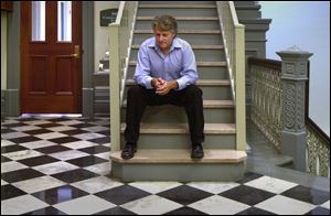 Patrick Garmyn of Wauseon waits alone in the hall during a recess in the hearing to determine his visitation rights.