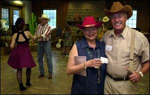 YEE HAW!: Joan and John Coleman suit up in western attire for the Wildwood Metropark barbecue in the pavilion.
 