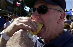 Butch Yates of Mobile, Ala., takes a big bite out of his Hungarian hot dog.