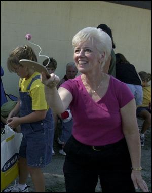 Linda Bristow tries paddle ball at the Everhardt reunion.