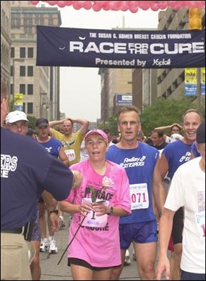 Deanna Kiesel of Findlay is the first cancer survivor to cross the finish line during the annual Race for the Cure in downtown Toledo. The elementary school guidance counselor completed yesterday's 5K race in 24 minutes, 5 seconds.