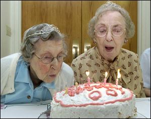 Mary Miller, left, and Florence Marx share a cake to celebrate their 100th birthdays at Browning Masonic Community in Waterville.