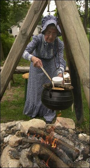 Katie Grimm of Pemberville serves bean soup outside the keeper's house, now a museum. Marblehead became a state park in 1998.