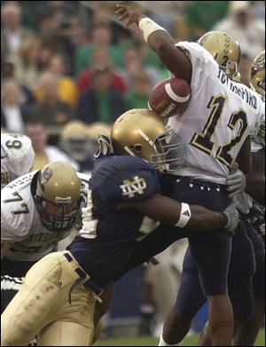Notre Dame linebacker Justin Tuck hits Pittsburgh quarterback Rod Rutherford, causing a fumble that the Irish recovered during the fourth quarter.