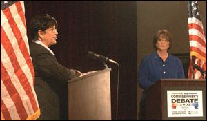 Lucas County Commissioner Sandy Isenberg, left, makes a point while Maggie Thurber listens during the debate at the University of Toledo. Ms. Isenberg, a Democrat, is being challenged by Ms. Thurber on the Nov. 5 ballot.