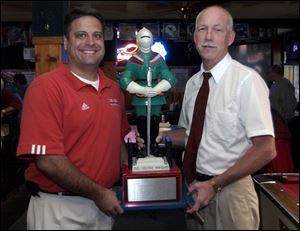 Central coach Greg Dempsey, left, would like to take the Irish Knight from St. Francis coach Dick Cromwell.