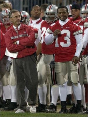 Coach Jim Tressel and injured running back Maurice Clarett enjoy the final seconds of Ohio State's victory.