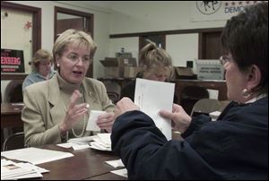 Marcy Kaptur, left, and Sandy Isenberg seal mailers at Lucas County Democratic headquarters in Toledo as fall election campaigns wind down.