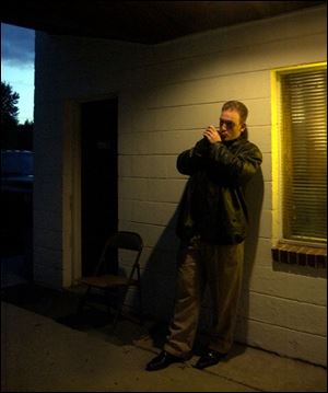 Johnny Reed plays his harmonica before a show at Hines Farm in Swanton.