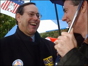 Ohio Gov. Bob Taft, left, talks with Congressman Rob Portman outside a polling location Tuesday.
