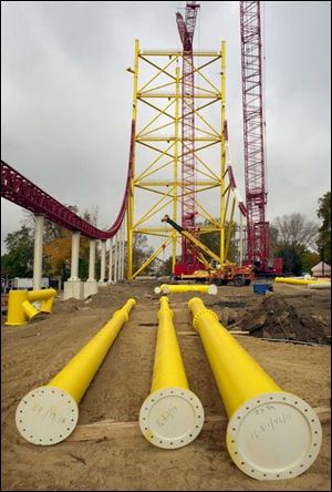 Red coaster track rises into the air and thick pipes are strewn around the site of the towering mystery ride Cedar Point is constructing near the Magnum XL-200.
