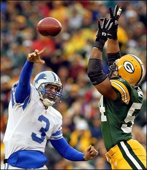 Detroit's Joey Harrington tries to get a pass by the outstretched arms of Green Bay's Nate Wayne.