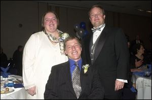 PARTY: Melinda Tulak, Brian Fitch, front, and Kevin Carmony are at the Goodwill dinner.