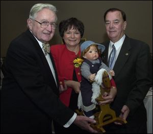 BENEFIT: Walter Grady, from left, Mary Ann Kania, holding a doll she made, and Jack Mixon at a dinner.