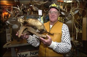 Master taxidermist Earl Wolfe, a retired biology teacher who lives in Oregon, holds his first piece of work. In five decades in business, he has mounted at least 5,000 deer heads.
