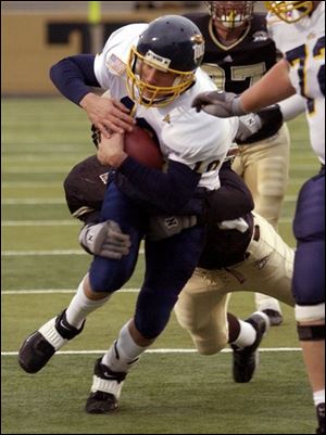 Toledo quarterback Brian Jones is dragged down from behind by Western Michigan's Bryan Lape. Jones carried eight times for 94 yards and threw for 207.