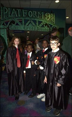 Elise Matney, 11, from left, Marcel Woods, 8, Eric Reynolds, 10, and Spencer Jacob, 7, dress up for a special showing of the latest Harry Potter film.