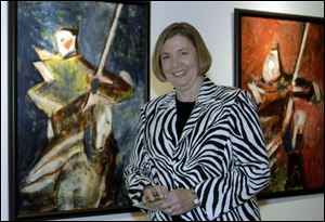 OPENING RECEPTION: Carol Block with her oil paintings, which were described as alive with colors and light.