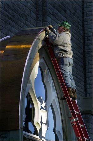 Bill Roth of Bay View Sheet Metal works on installing new  copper sheeting on the entrance way roof  of Trinity Church in downtown Toledo. Lisa dutton ROV copper DEC 9 2002