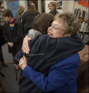 Superintendent Sharon Stannard is hugged by teacher Holly Clouse during the reception at the middle school.