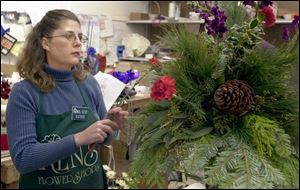 Kathie VanNess creates an arrangement using a variety of greenery.