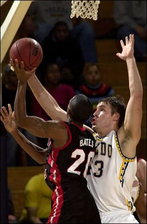 Toledo's A.J. Shellabarger gets a block against Northern Illinois' Jay Bates during the first half last night at Savage Hall. Bates scored 23 points to lead the Huskies as they pulled away from the Rockets early.