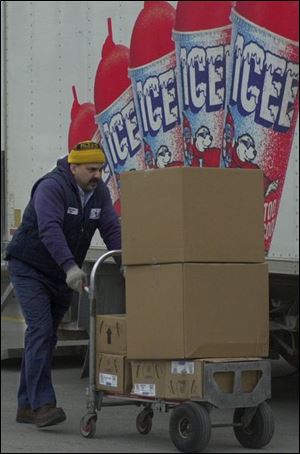 Despite the frigid temperatures outside, Haik Karapetian delivers another load of Icee products to the Kmart on Navarre Avenue in Toledo. Forecasters say the bitter cold will continue through the weekend with the highs in the low 20s and overnight lows in the teens.