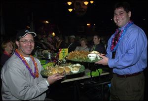 SEAFOOD SERVINGS: Andy Anderzak, left, and Brian Epstein, co-chairmen of the Barefoot at the Beach party, pass around some of the abundant seafood platters.