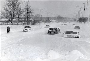 On the second day of the Blizzard of '78, traffic on Heatherdowns Boulevard remained frozen by incapacitating snow that drifted over city streets.