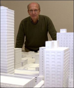 ‘We want to provide some harmony,' says Bob Seyfang, retired architect and developer, at Design Center headquarters on North Huron Street behind a tabletop model of downtown Toledo.