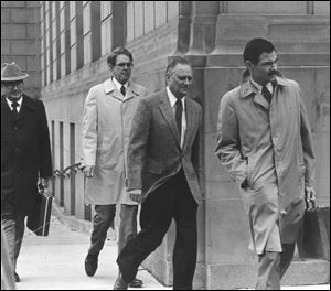 Edward P. Wolfram, second from right, leaves the federal courthouse in Toledo during his April, 1983 trial.
